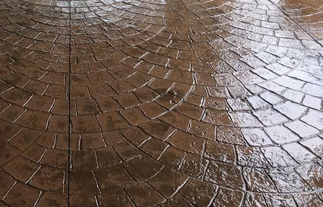 A close up of a brick floor with a circular pattern