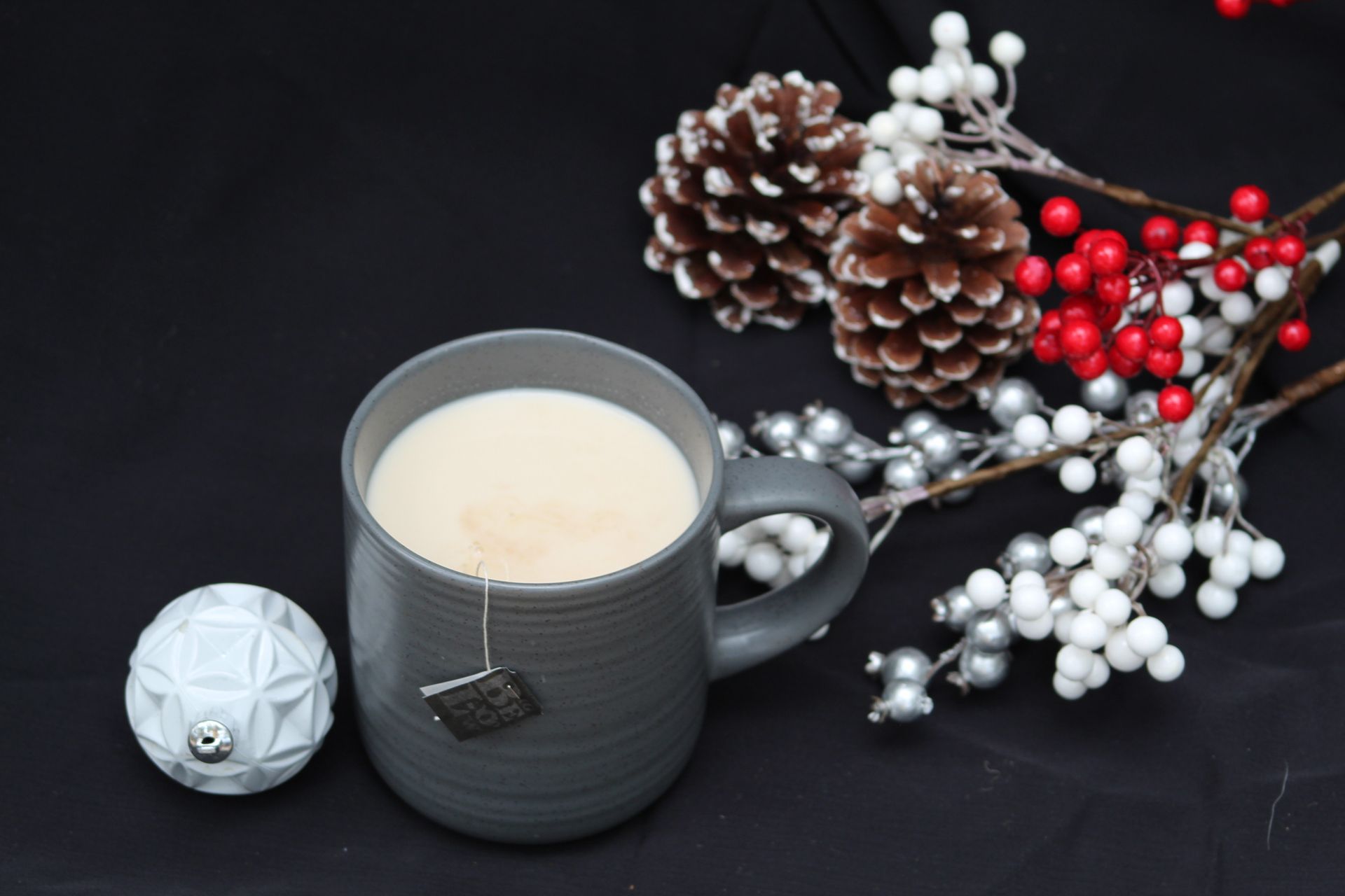 Pineapple cocktail in a clear plastic cup with a straw, garnished with pineapple and mint.