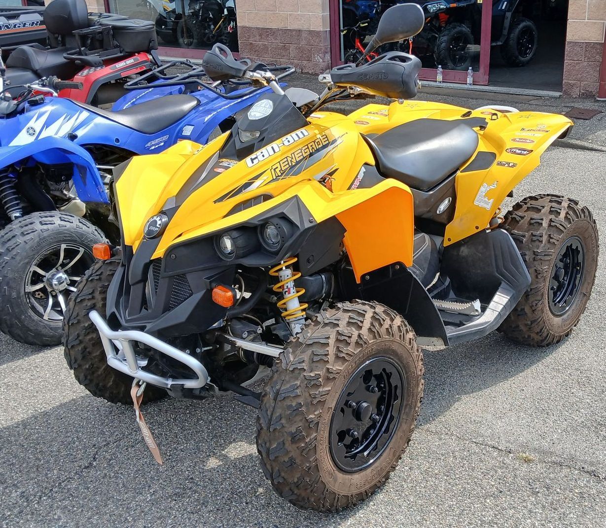 Quad giallo e nero con ruote nere parcheggiato all'esterno.