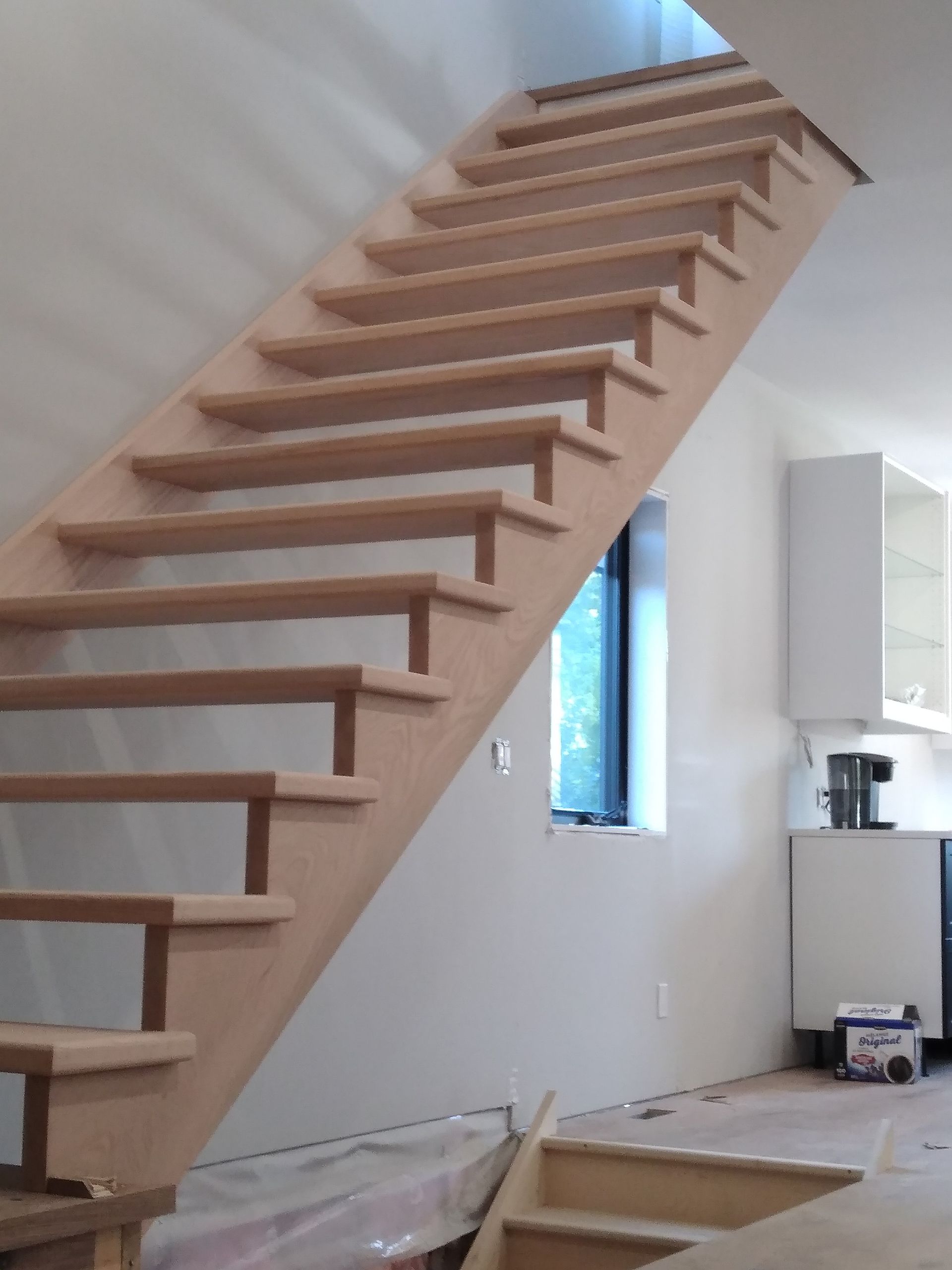 Wooden floating staircase with open treads.