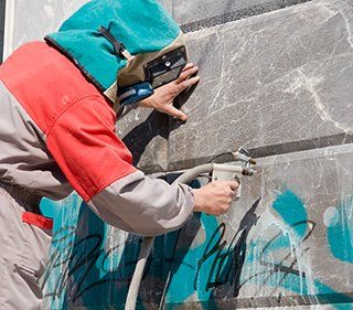 Technician Eliminating Graffiti
