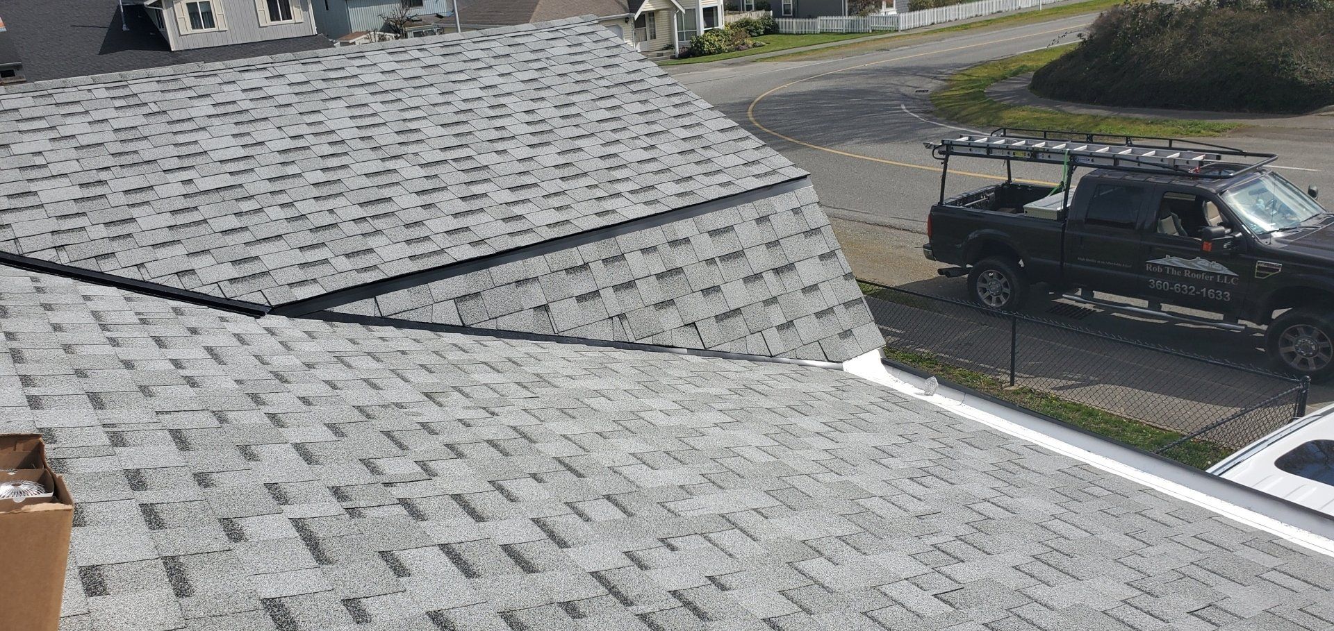 A truck is parked on the roof of a house.