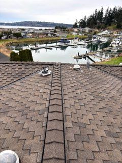 A roof with a view of a marina and a body of water.