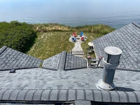 A view of the ocean from the roof of a house.