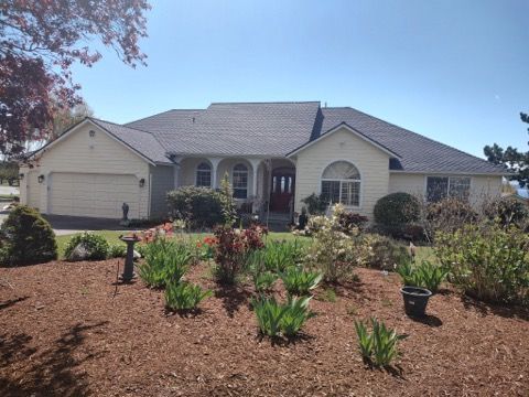A large white house with a gray roof