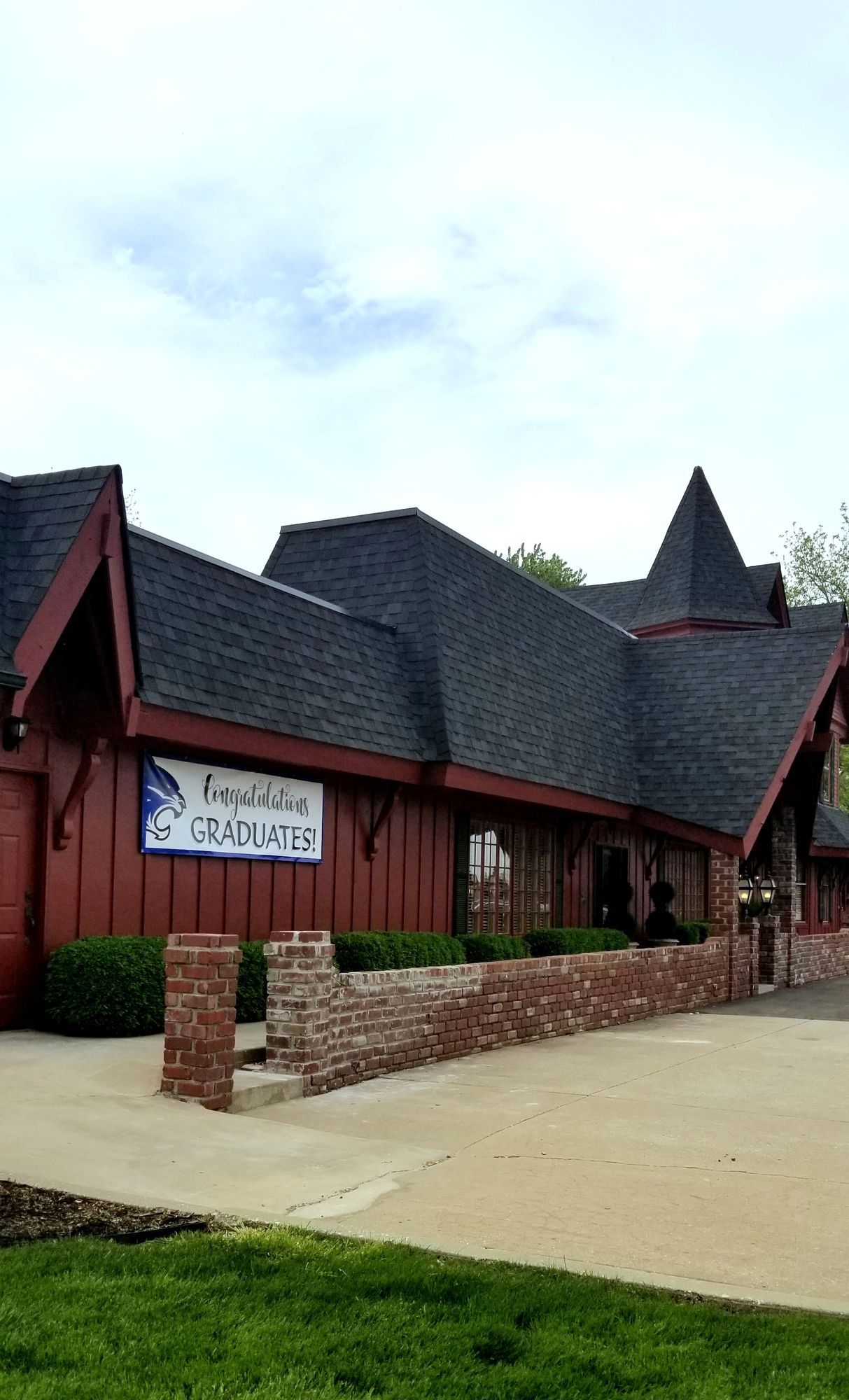 Red building with black roof, sign says