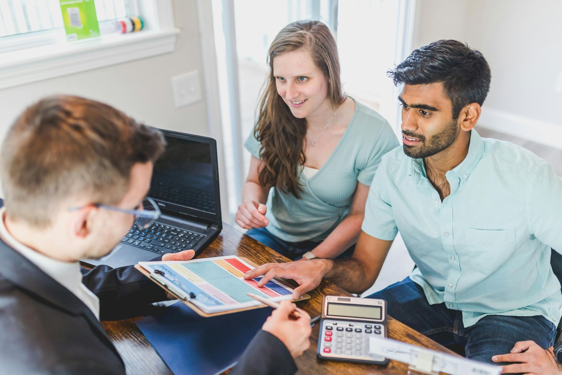 Three people reviewing financial documents.