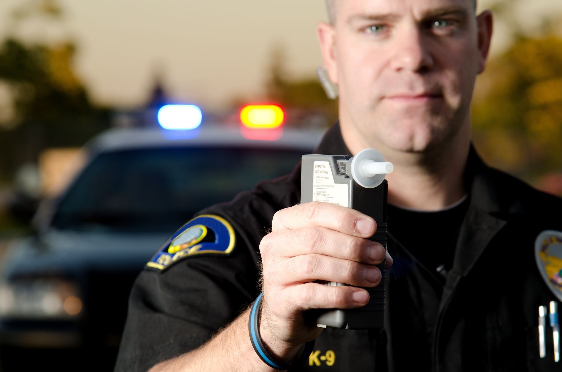 A police officer showing a breathalyzer at DUI check point. Attorney Ernesto Gonzalez in Orlando FL. Article on types of accidents and how to avoid them.