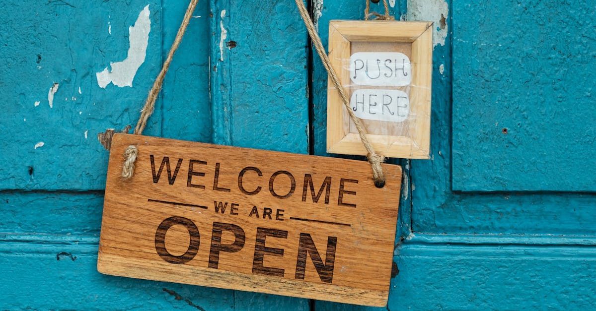 A wooden welcome sign is hanging on a blue door. To illustrate, a lawyer should always be accessible to the client by Attorney Ernesto Gonzalez