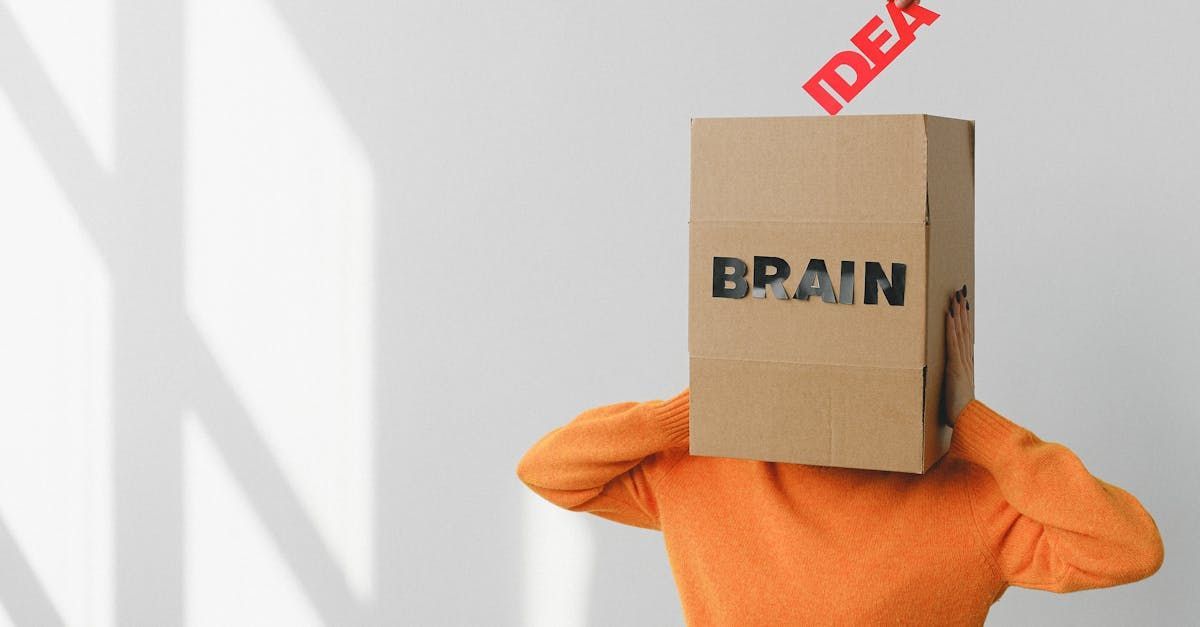 A person wearing an orange sweater holds a cardboard box on their head to illustrate that you should understand everything about an auto accident case with the help of a lawyer by Attorney Ernesto Gonzalez