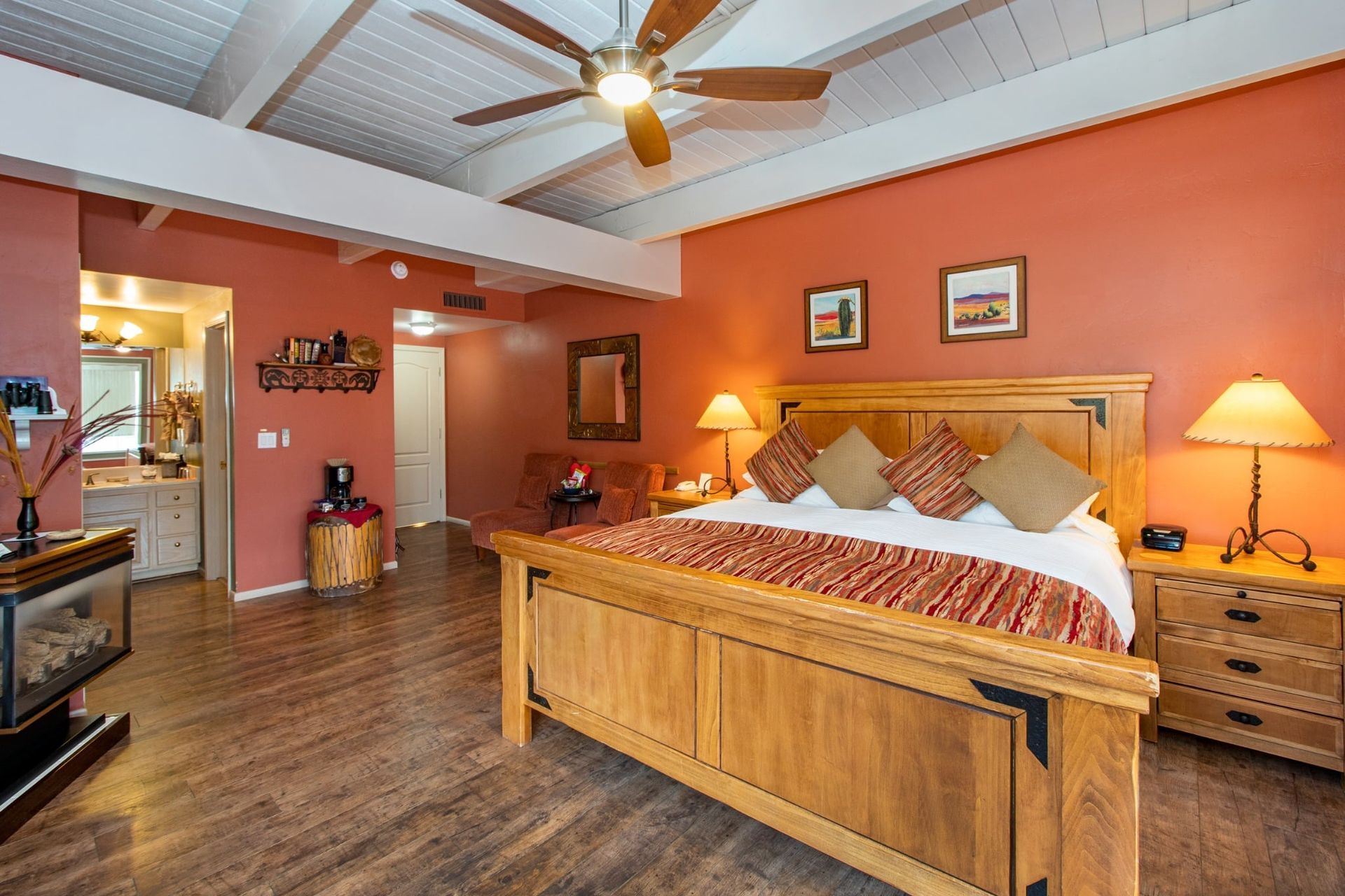 A bedroom with a king size bed and a ceiling fan.