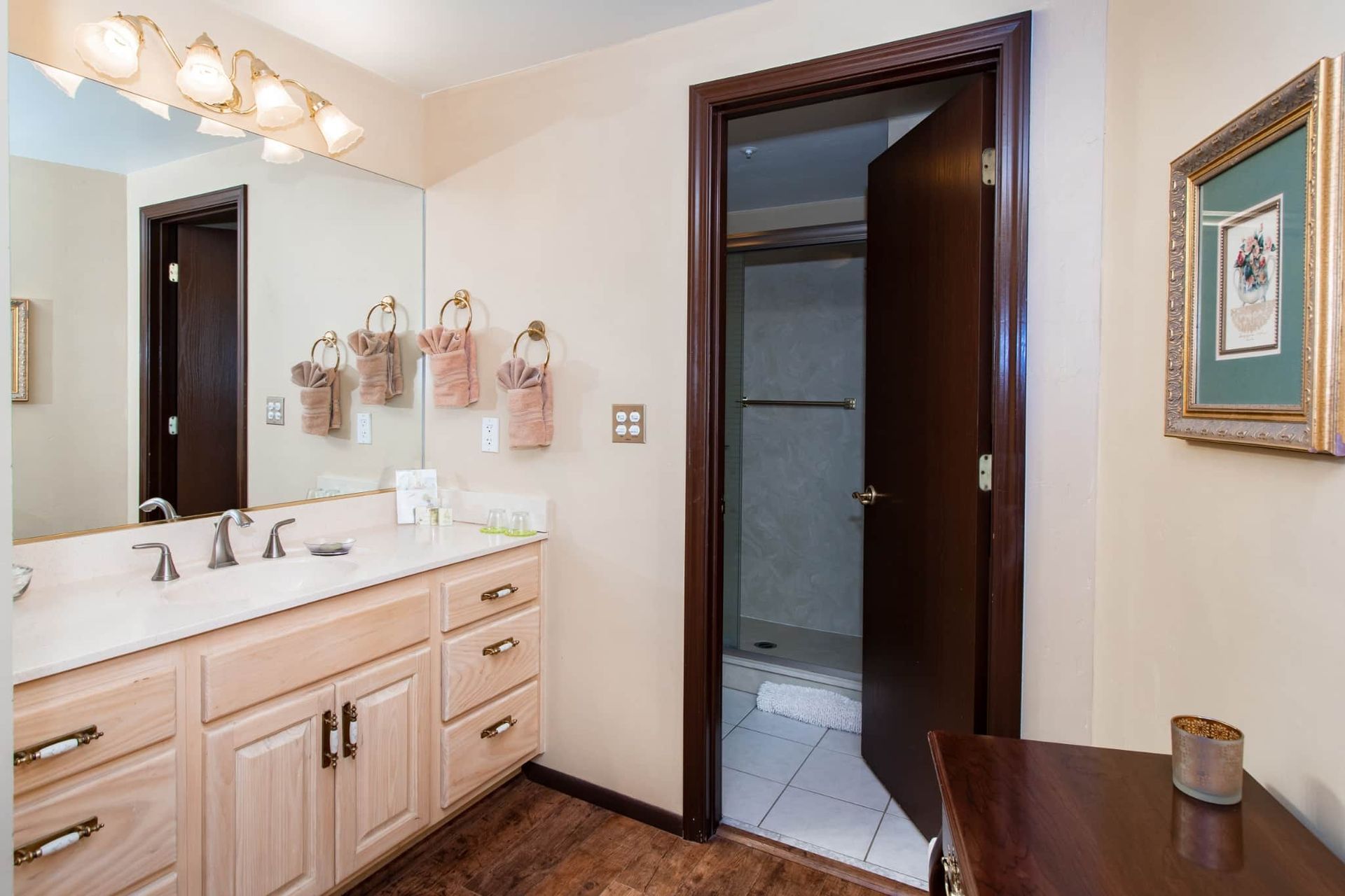 A bathroom with two sinks , a mirror , and a table.