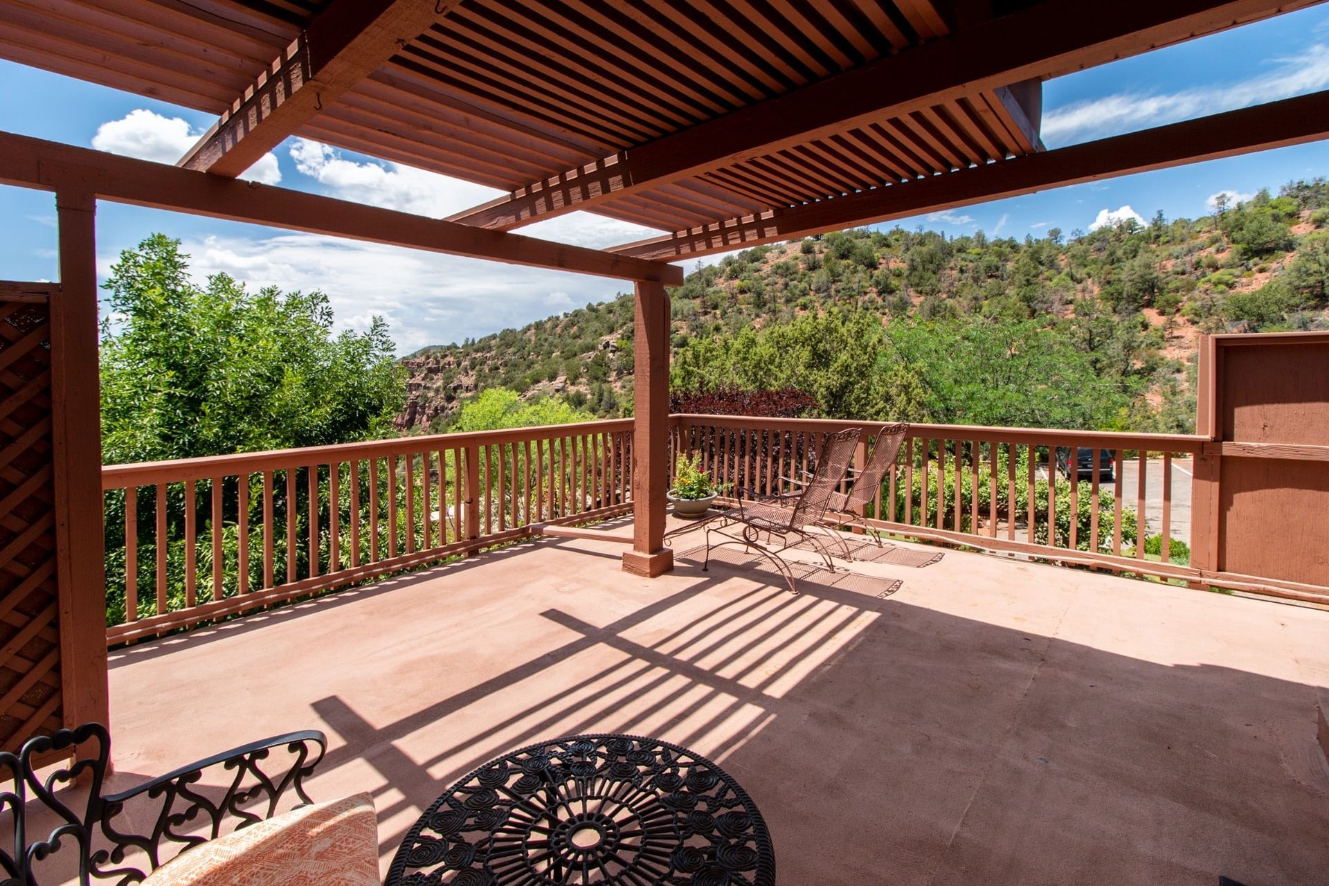 A patio with a table and chairs under a pergola