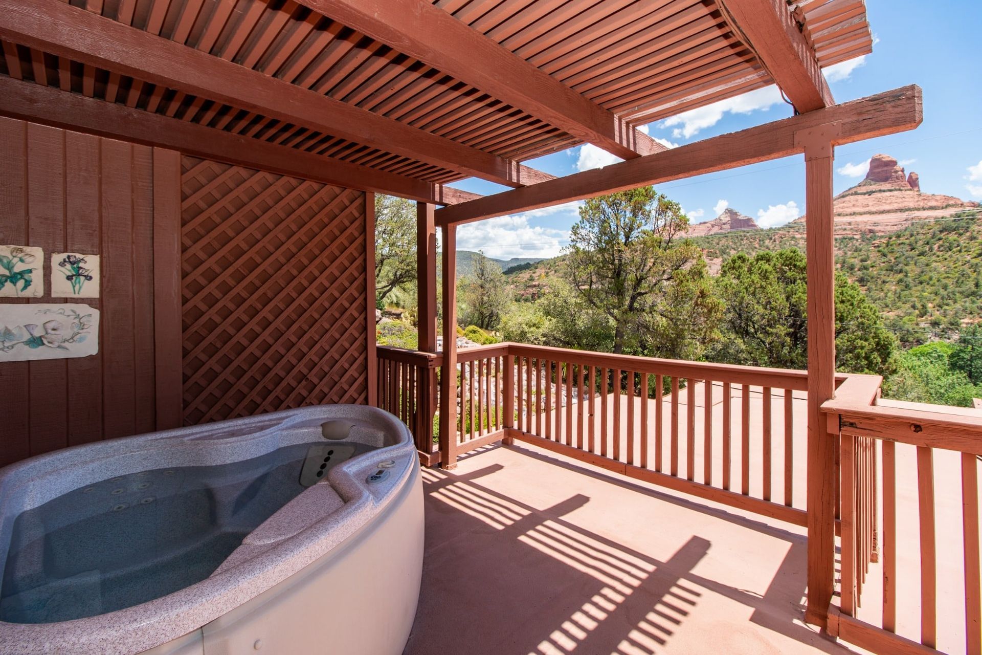 There is a hot tub on the deck of a house.