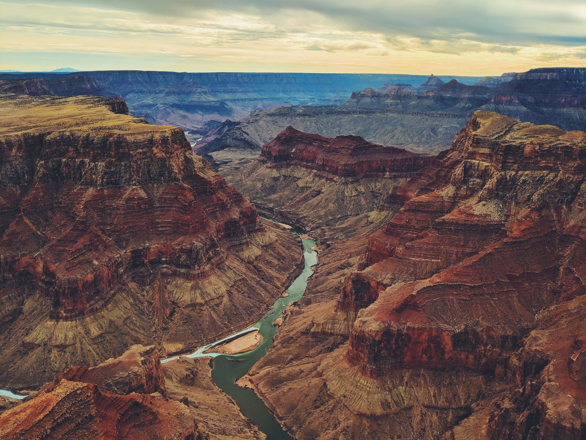 An aerial view of the grand canyon with a river running through it.