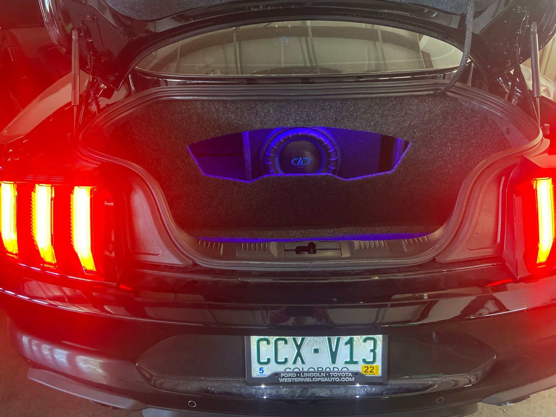 A black car with a license plate that says ccx v13