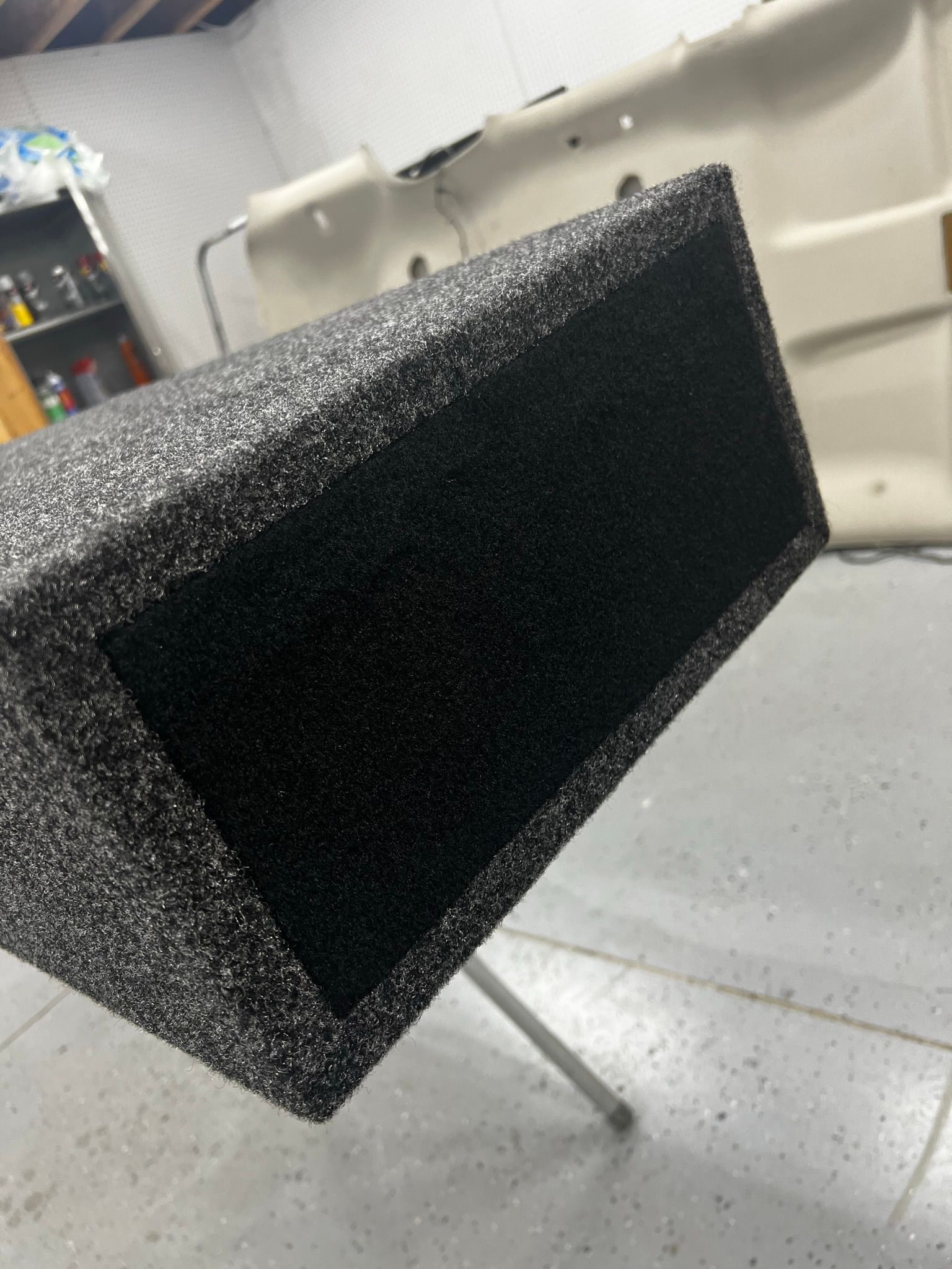 A black box is sitting on a table in a garage.