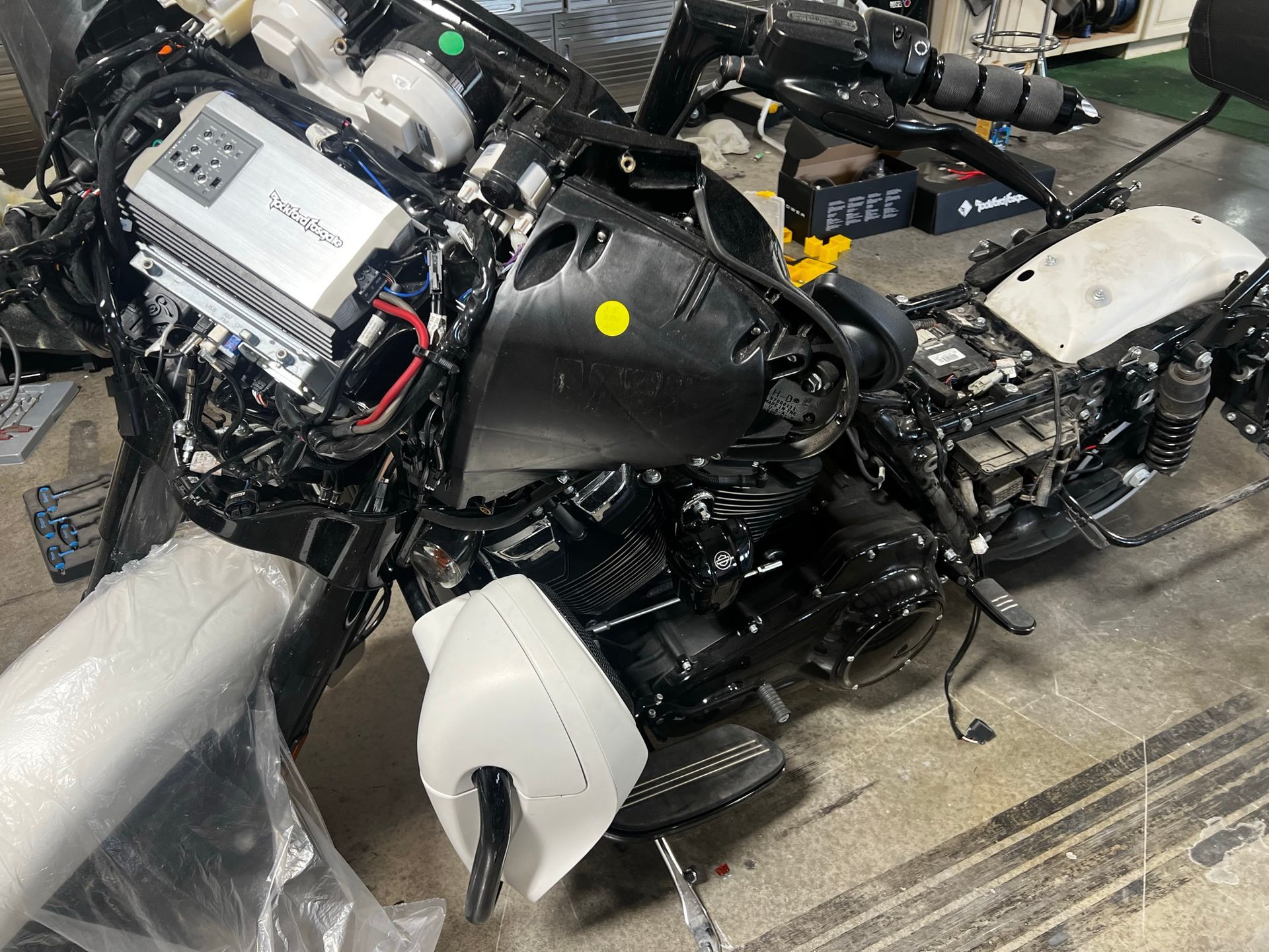 A motorcycle is being dismantled in a garage.