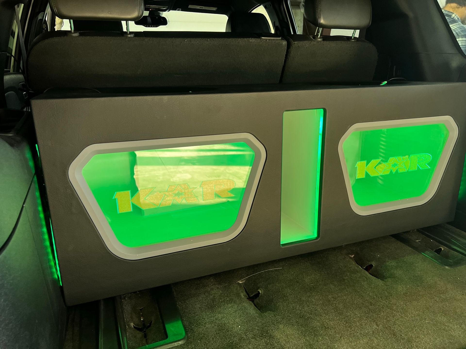 The back of a car with a speaker box that says i-force