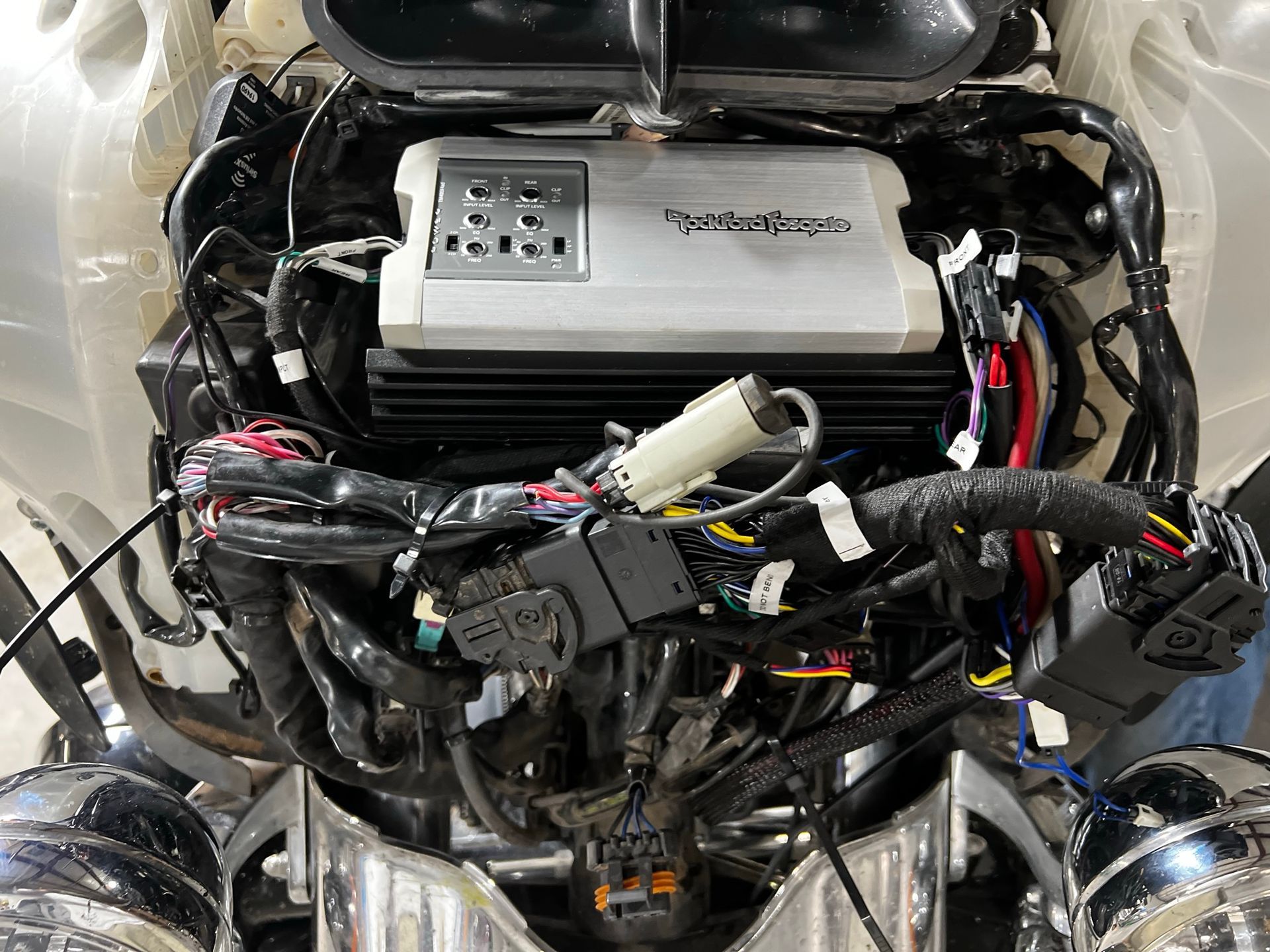 A close up of a motorcycle engine with a power amplifier.