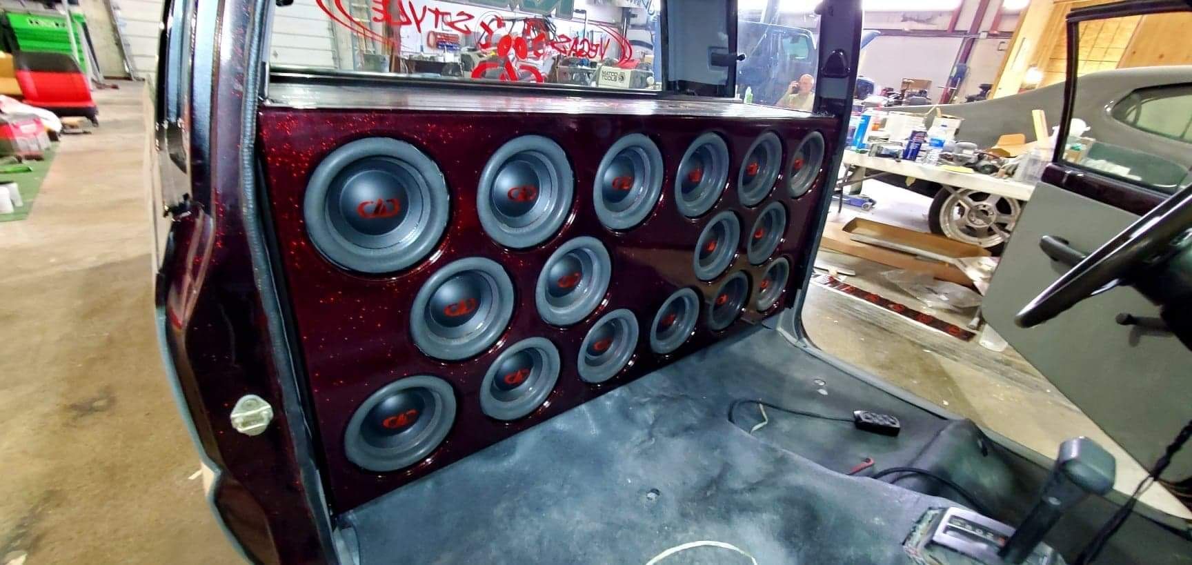 A car with a lot of speakers in the back of it.