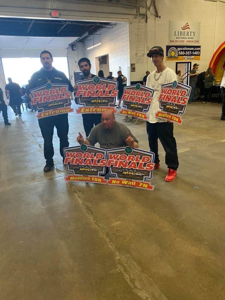 A group of men are holding signs in a building.