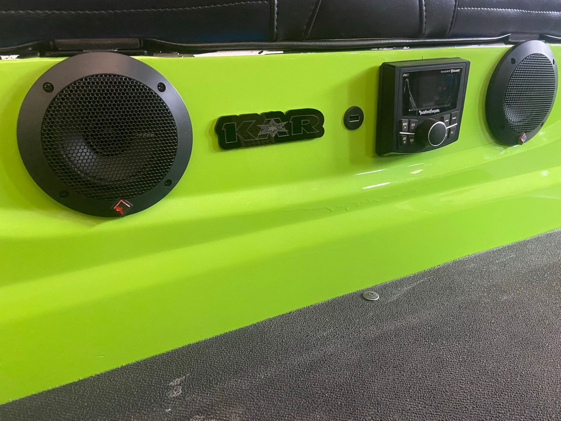 A green wall with speakers and a radio on it