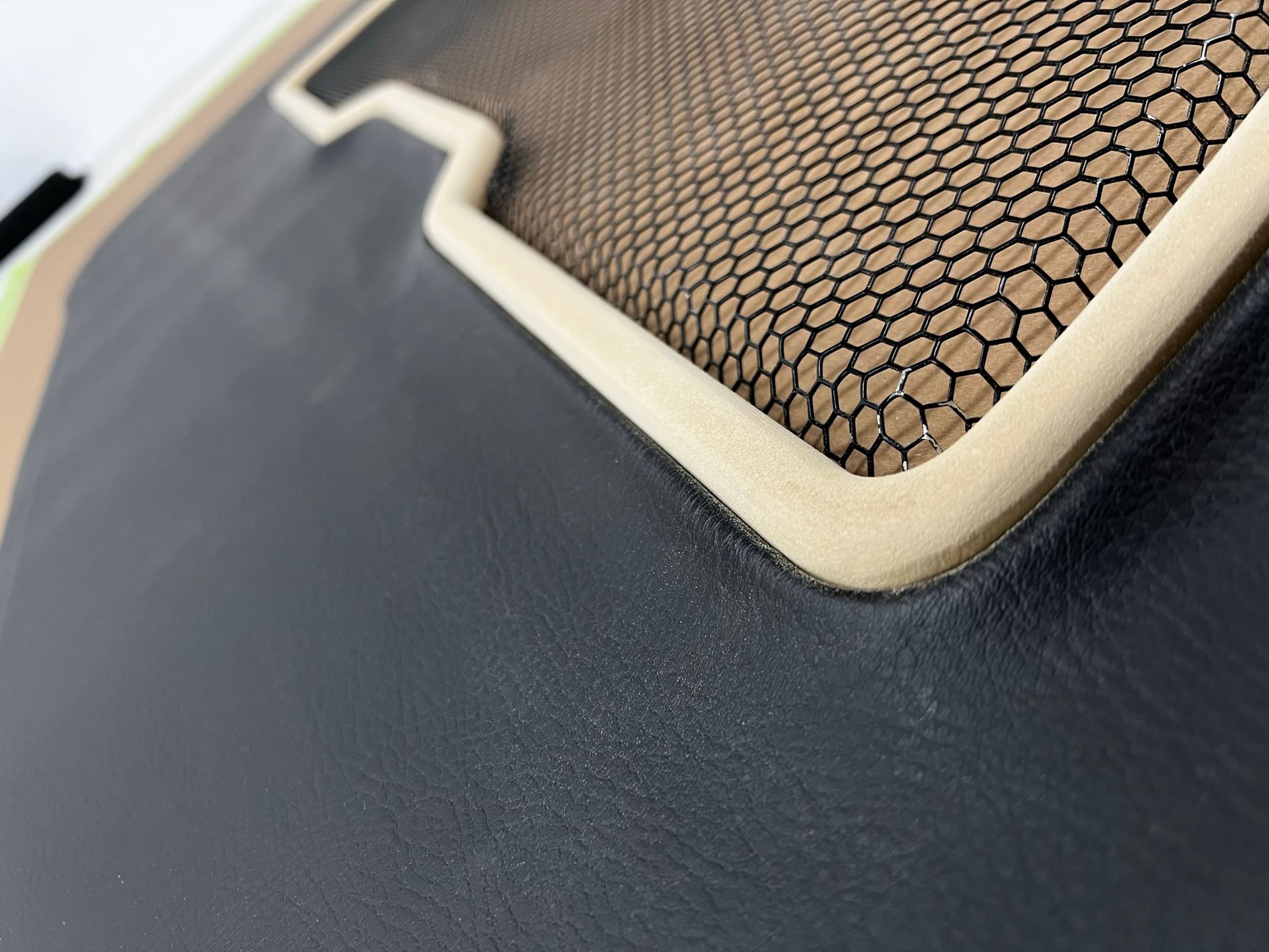 A close up of a piece of leather with a mesh on it.