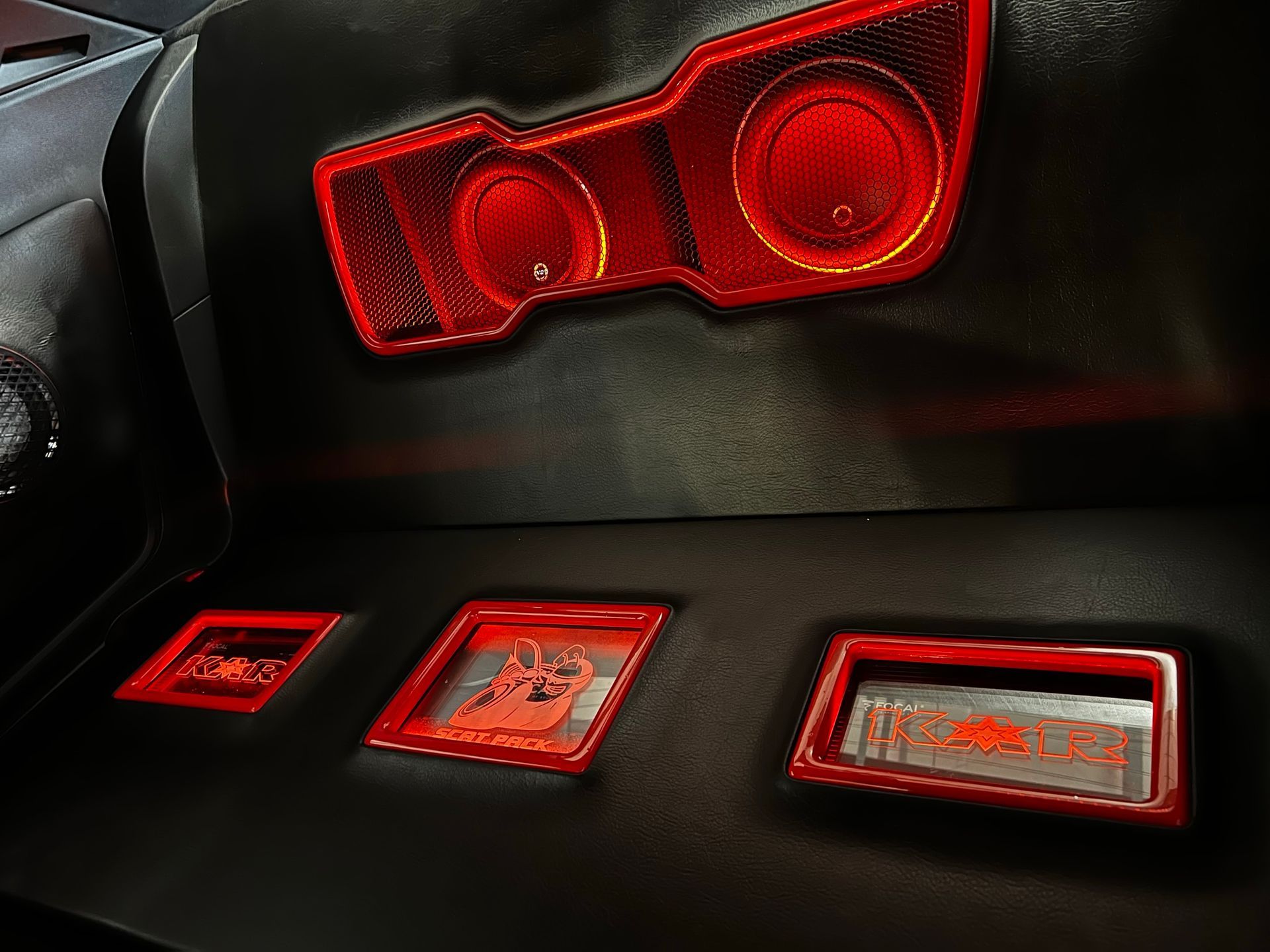 The back of a car with a red speaker on it