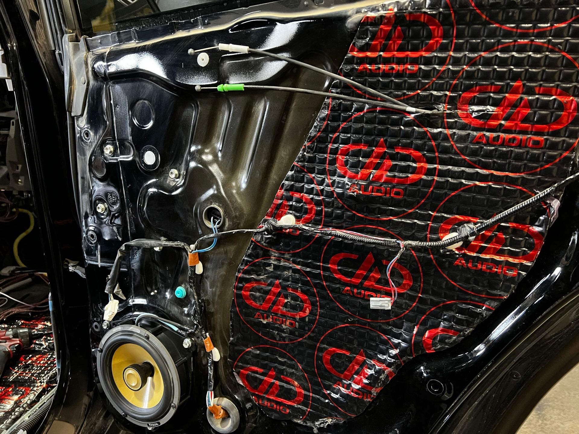A close up of a car door with speakers on it.