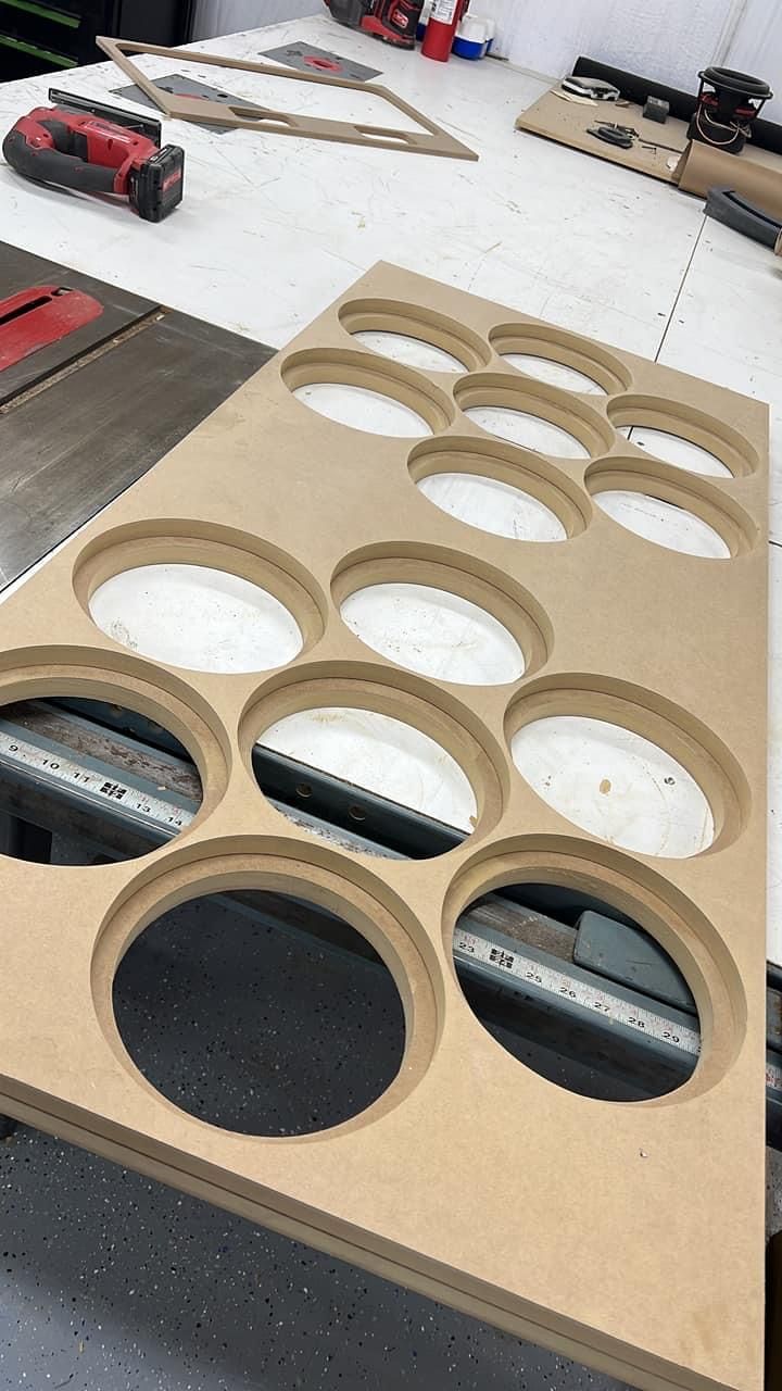 A piece of wood with holes in it is sitting on a table.