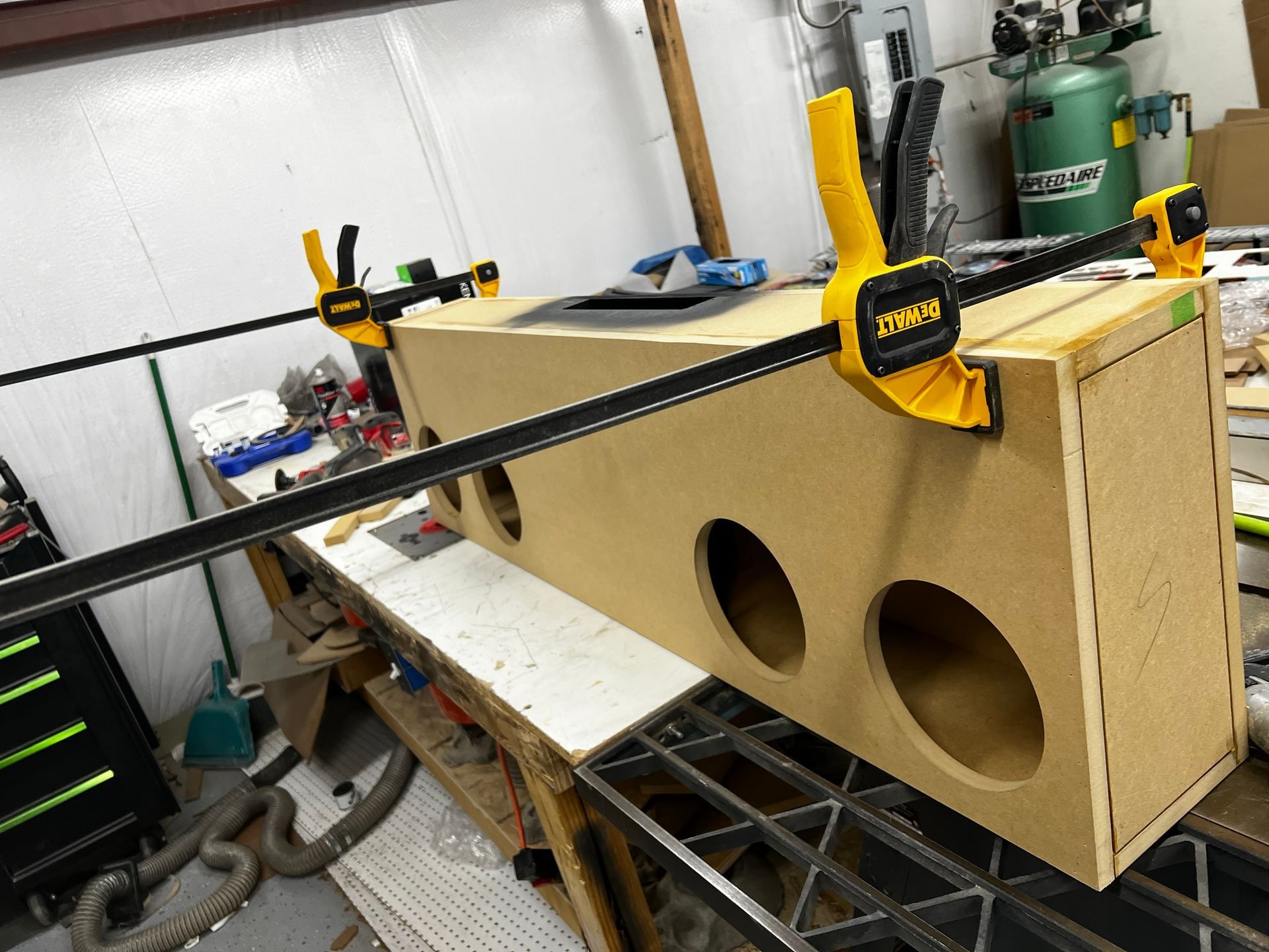 A dewalt clamp is being used to hold a piece of wood