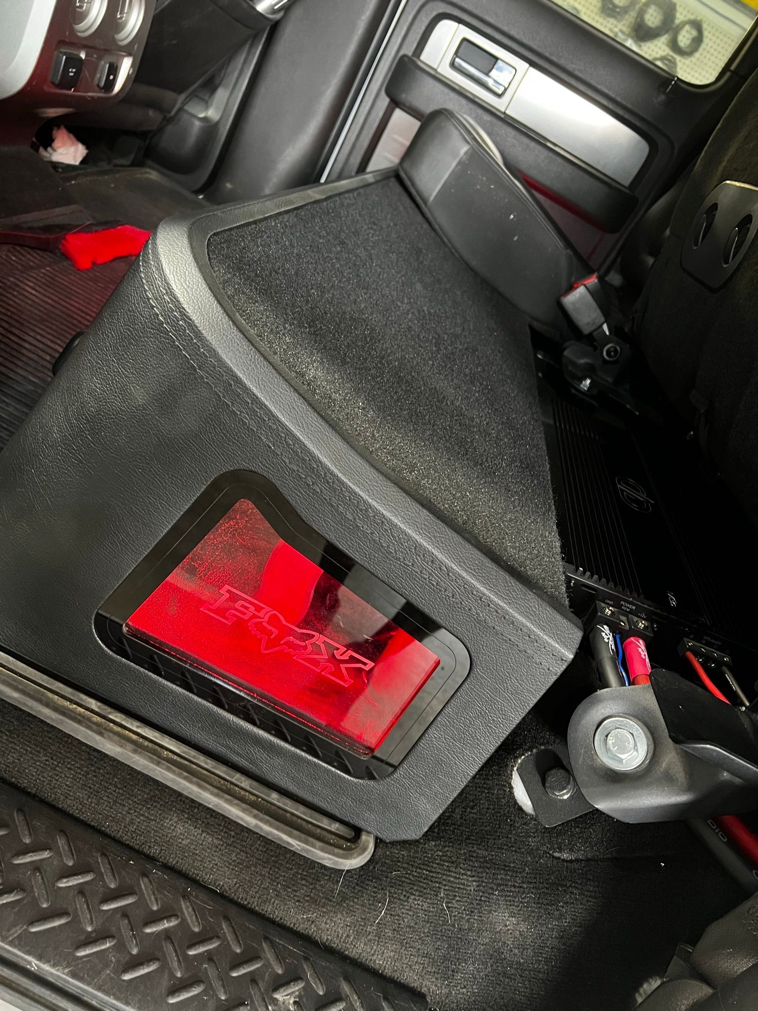 A black box with a red light inside of a car.