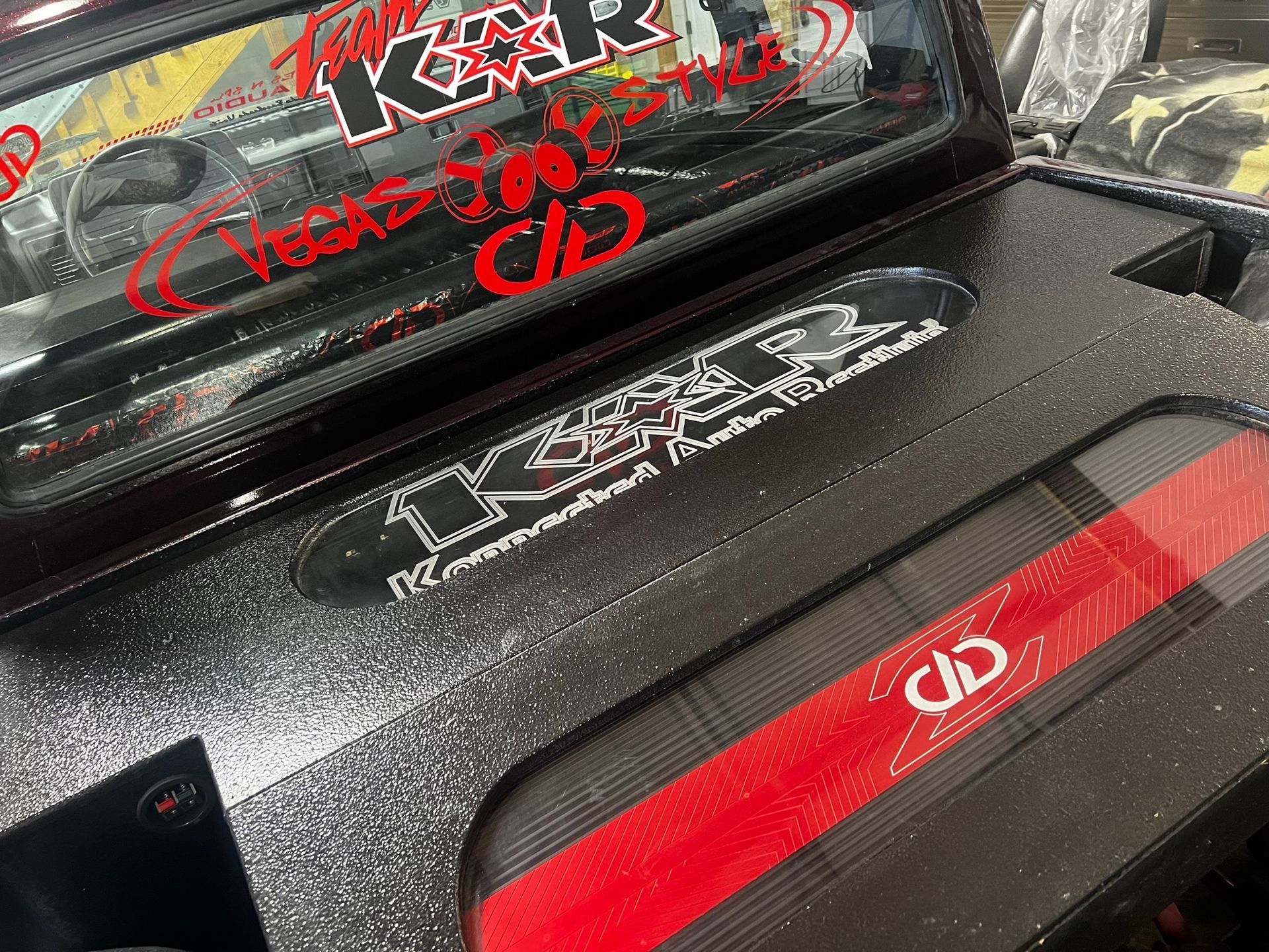 A close up of a jeep with a sticker on the windshield that says k & r