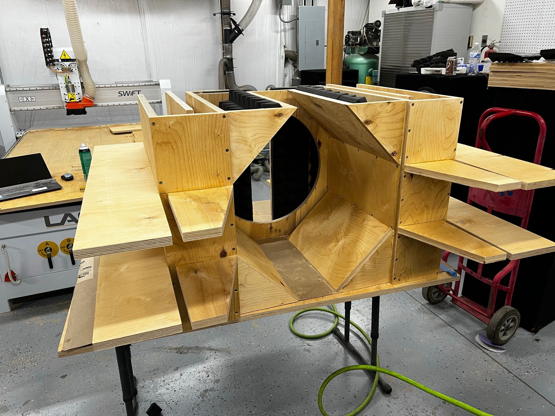 A wooden box is sitting on top of a table in a workshop.