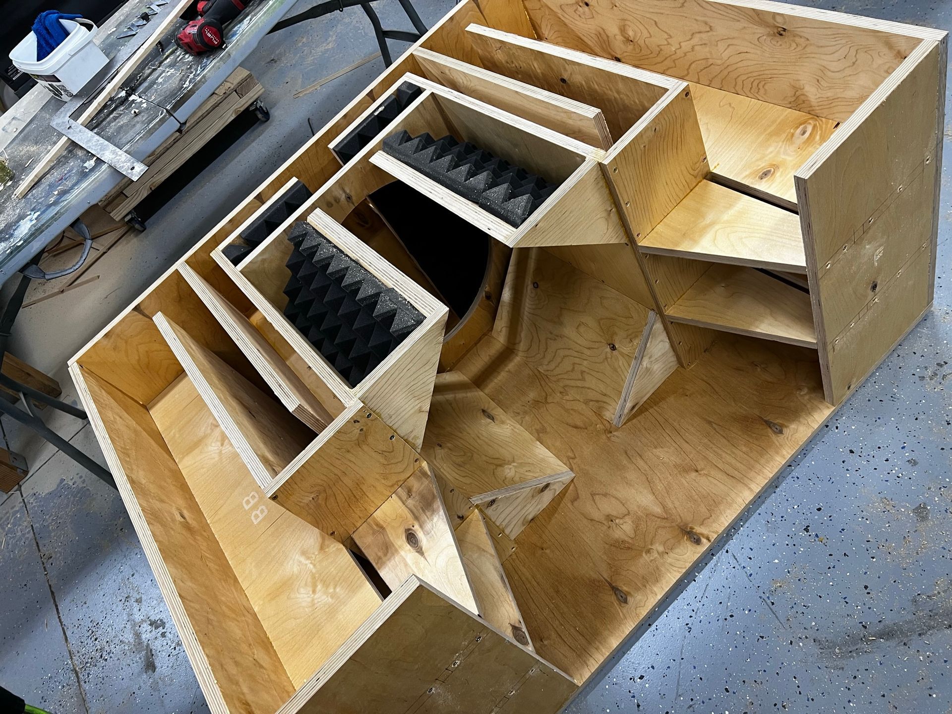 A wooden box is sitting on a table in a garage.