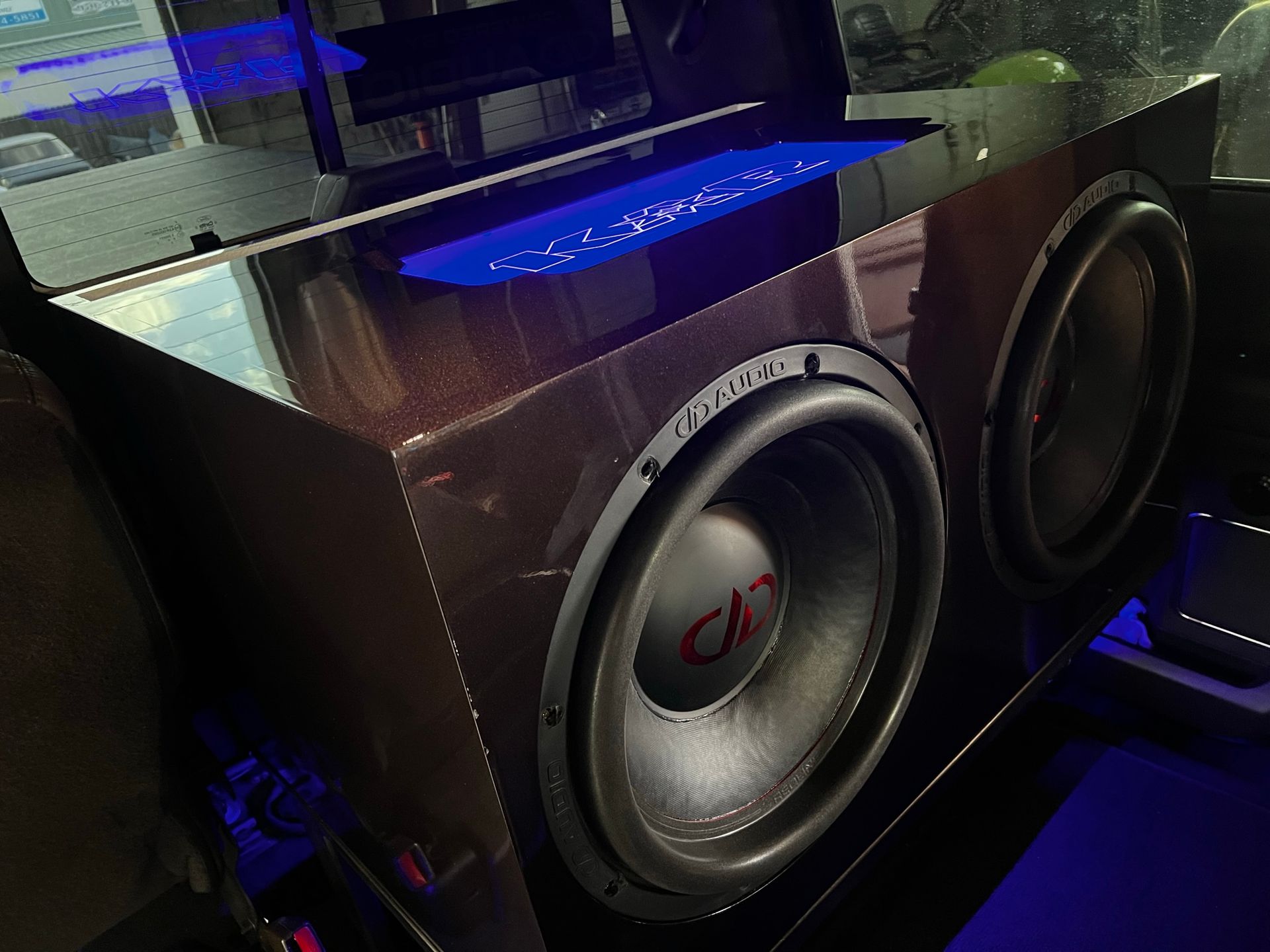A subwoofer is sitting in the back of a car