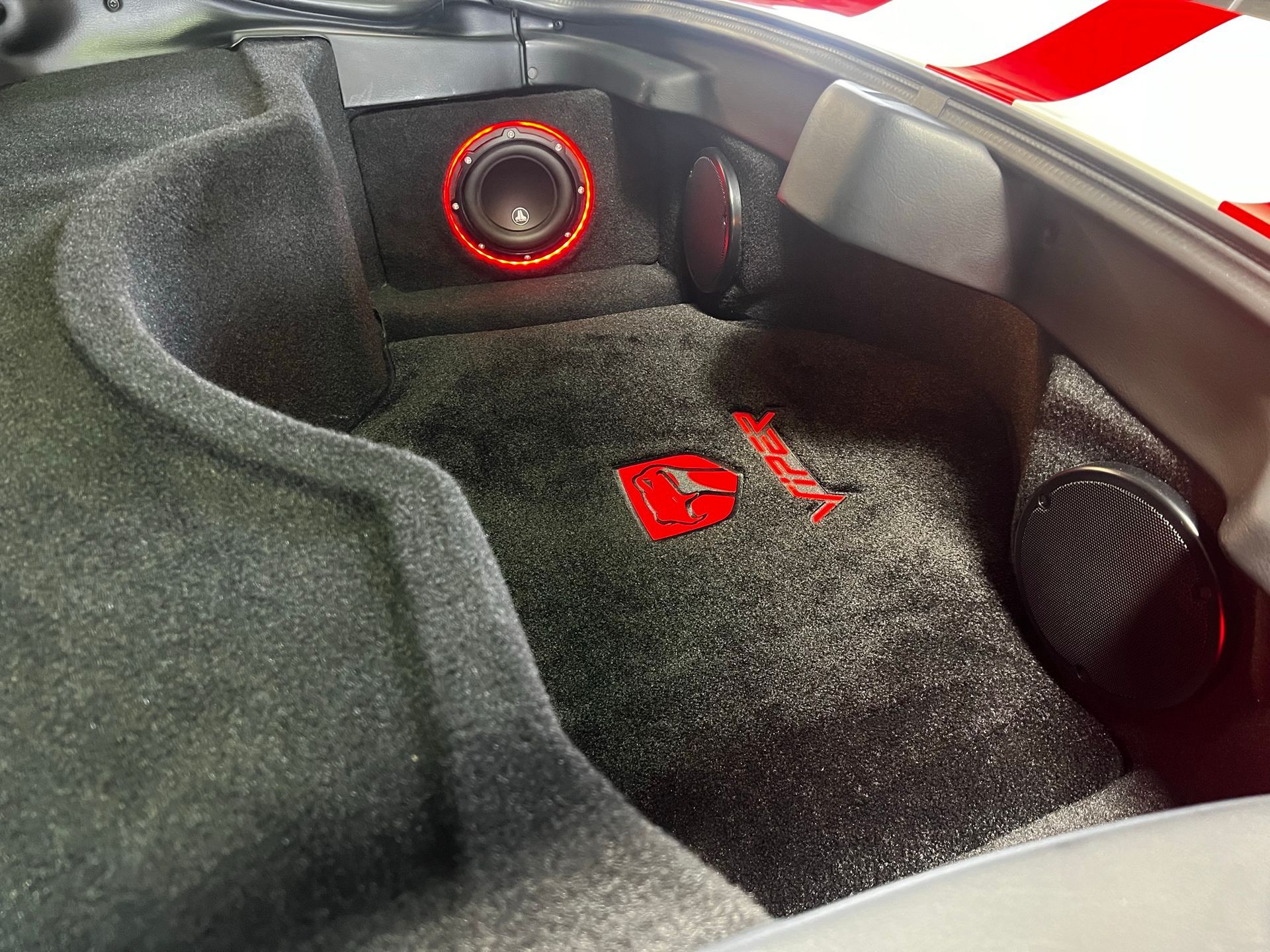 The trunk of a car has a subwoofer in it