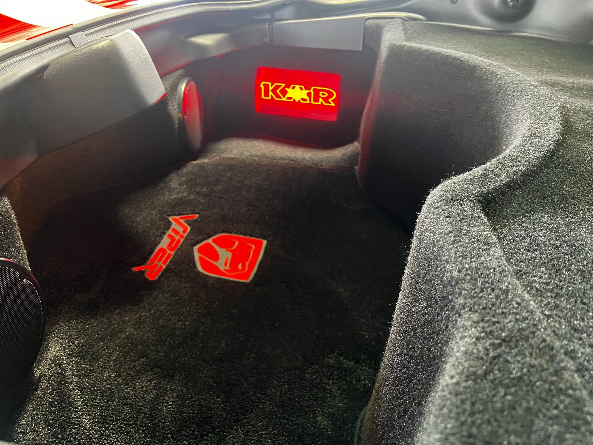 The trunk of a car has a red light that says k on it