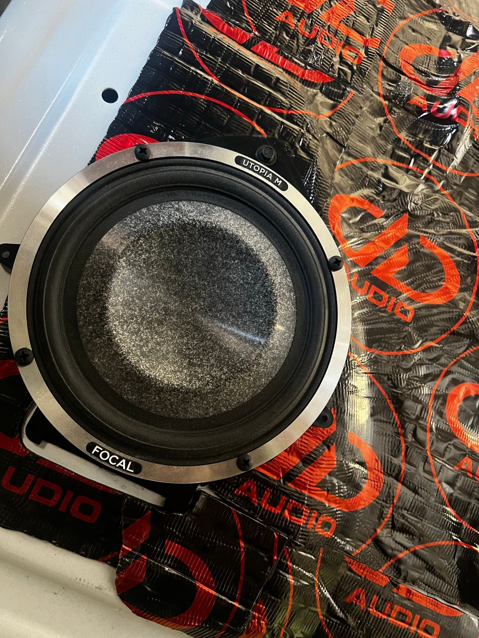 A speaker is sitting on top of a piece of foam.