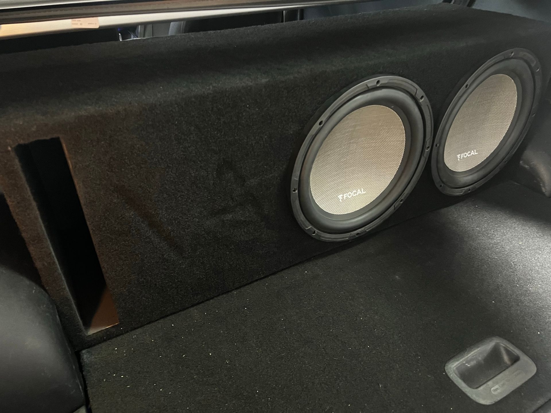 A subwoofer is sitting in the back of a car