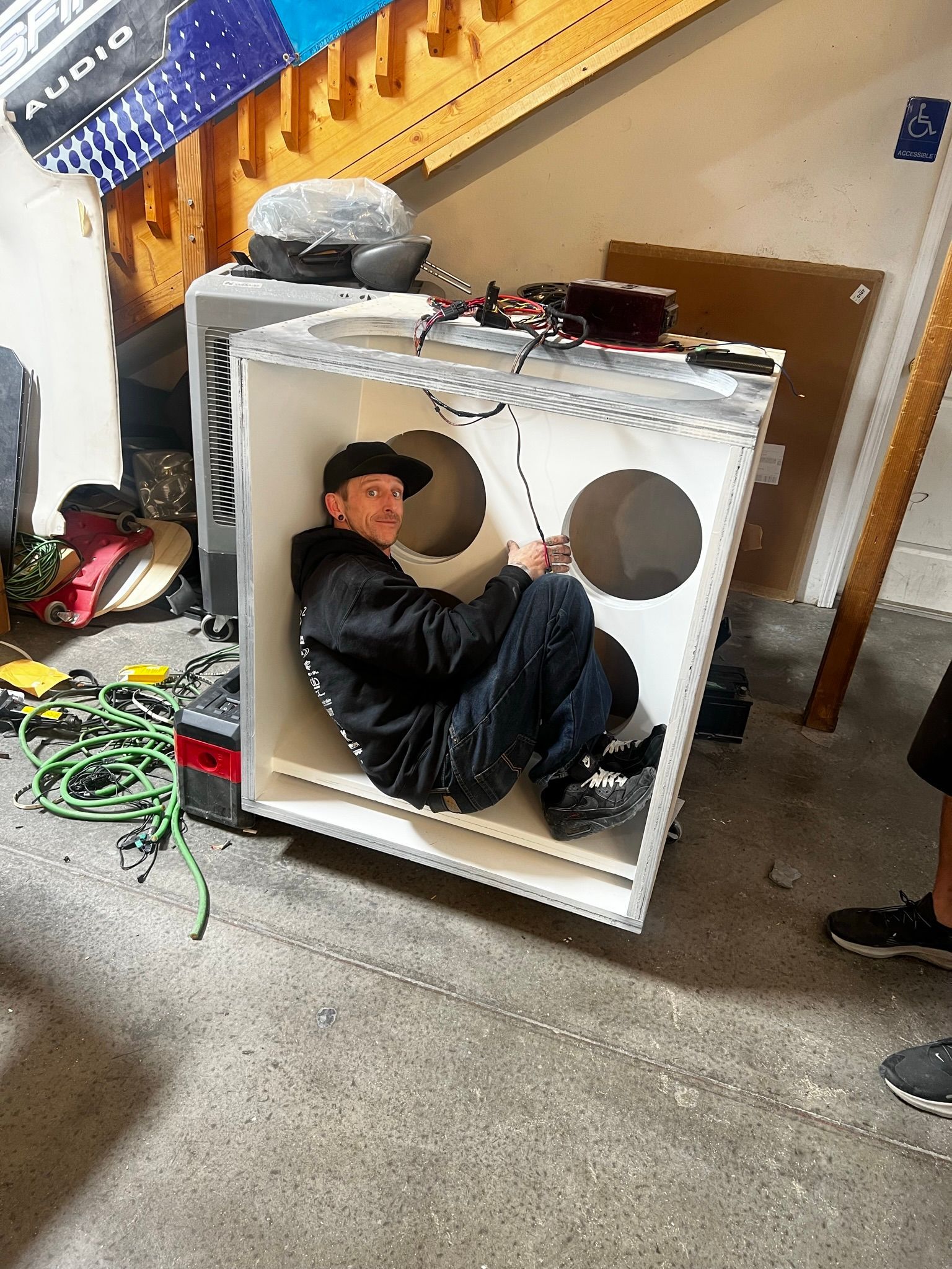 A man is sitting inside of a box.