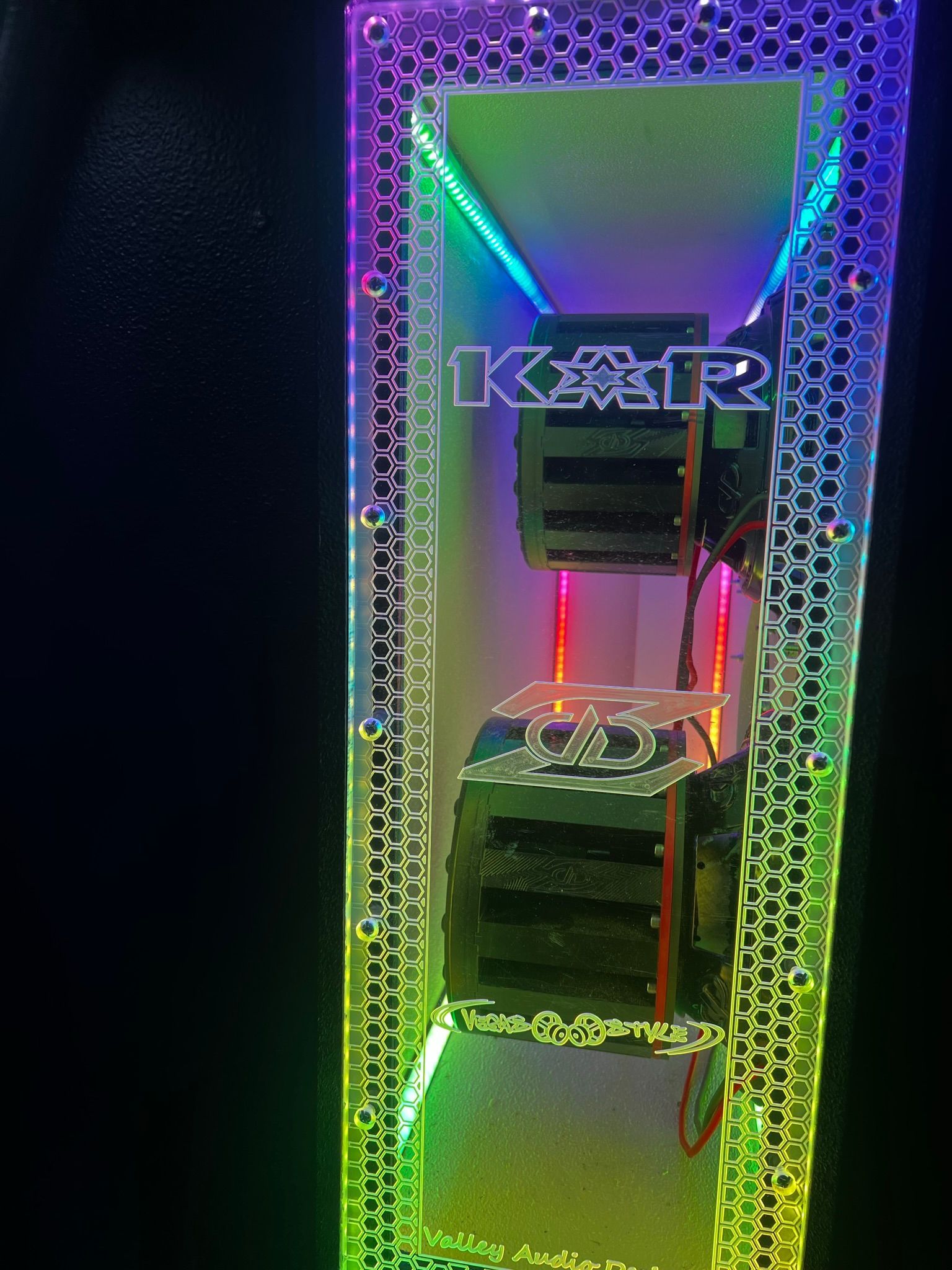 A computer case with a rainbow of lights on it.