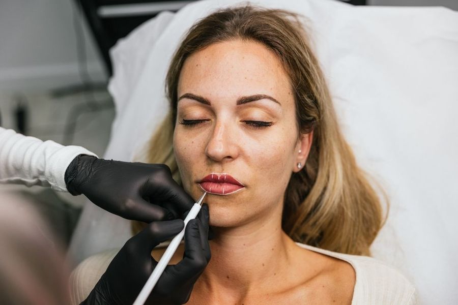 A woman is getting a lip injection in a beauty salon.