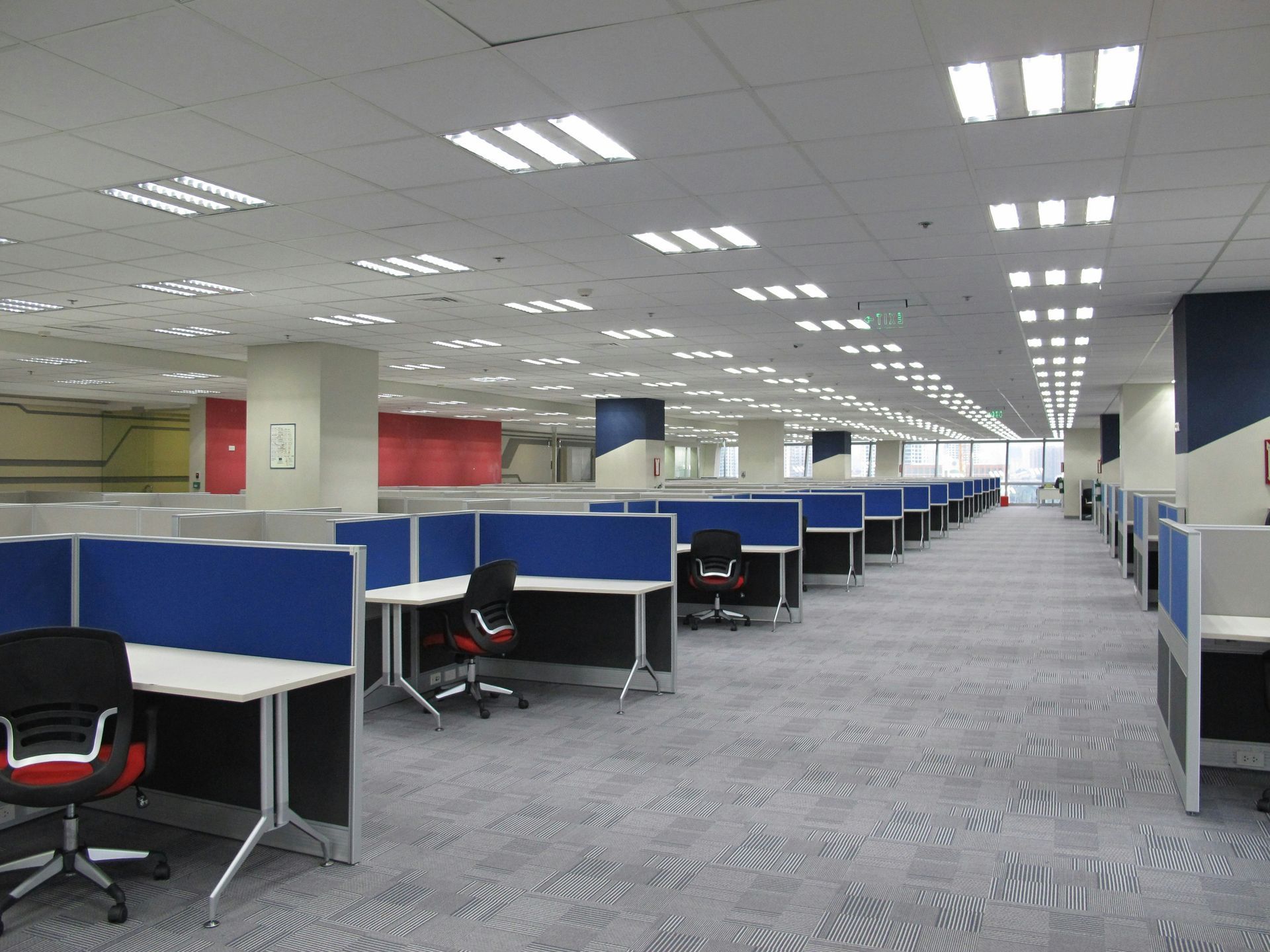 A large office with a lot of cubicles and chairs