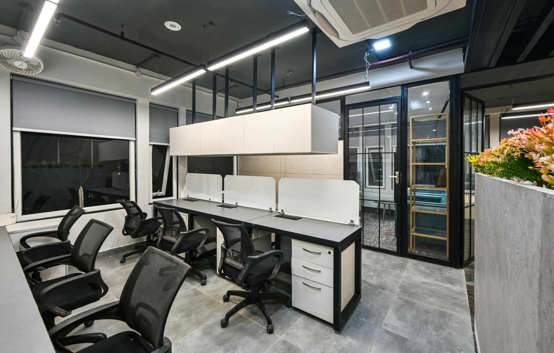 A modern office with a lot of desks and chairs.