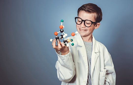 young boy in lab coat