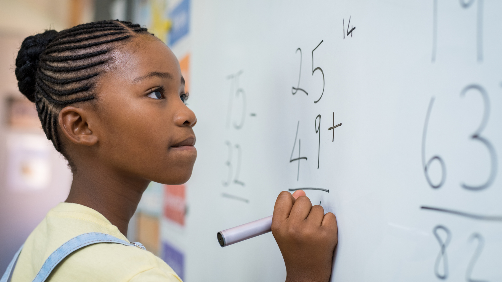 An elementary student working on math