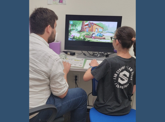 one teacher and one student studying at computer