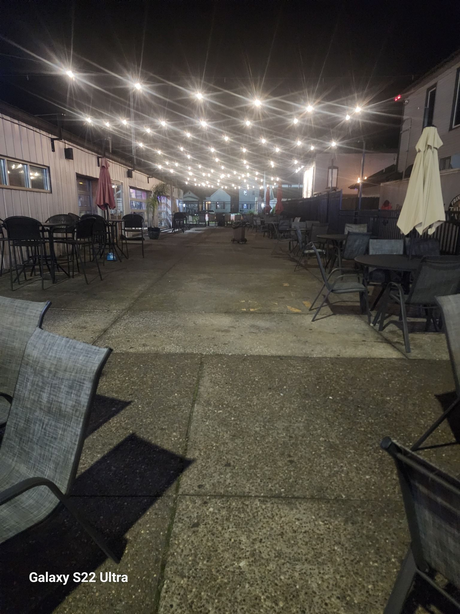 A man is cleaning a desk with a cloth and spray bottle.